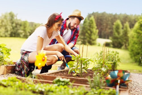 Local gardener trimming hedges and caring for plants in Oakleigh Park